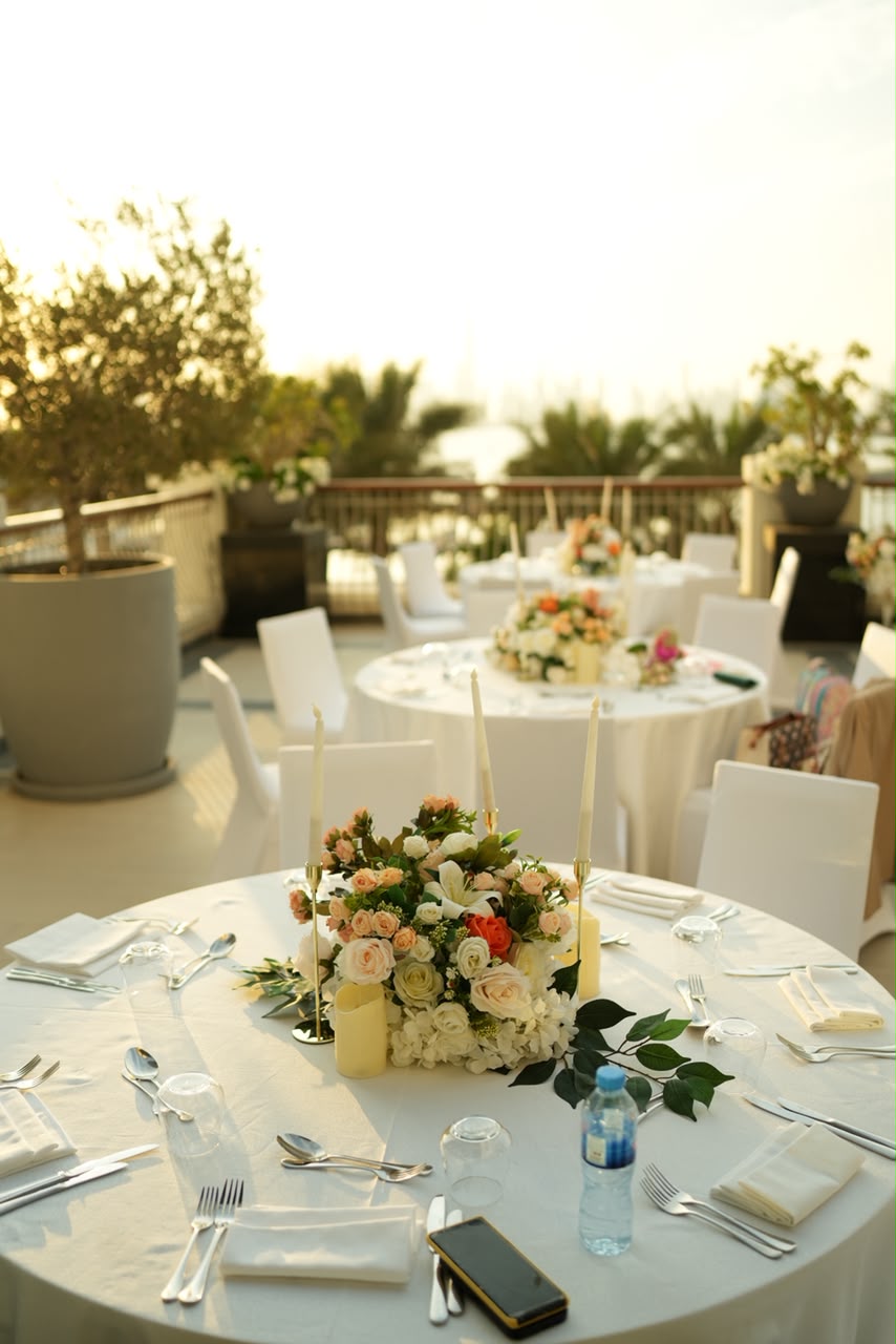 Waterfront wedding terrace with an elegant table setting overlooking the water in the UAE